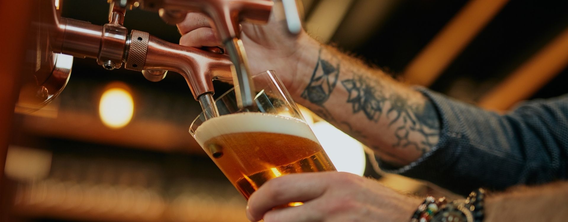 Draft beer being poured from a tap